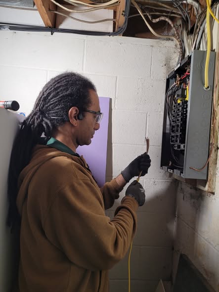Electrician working on shed electrical wiring