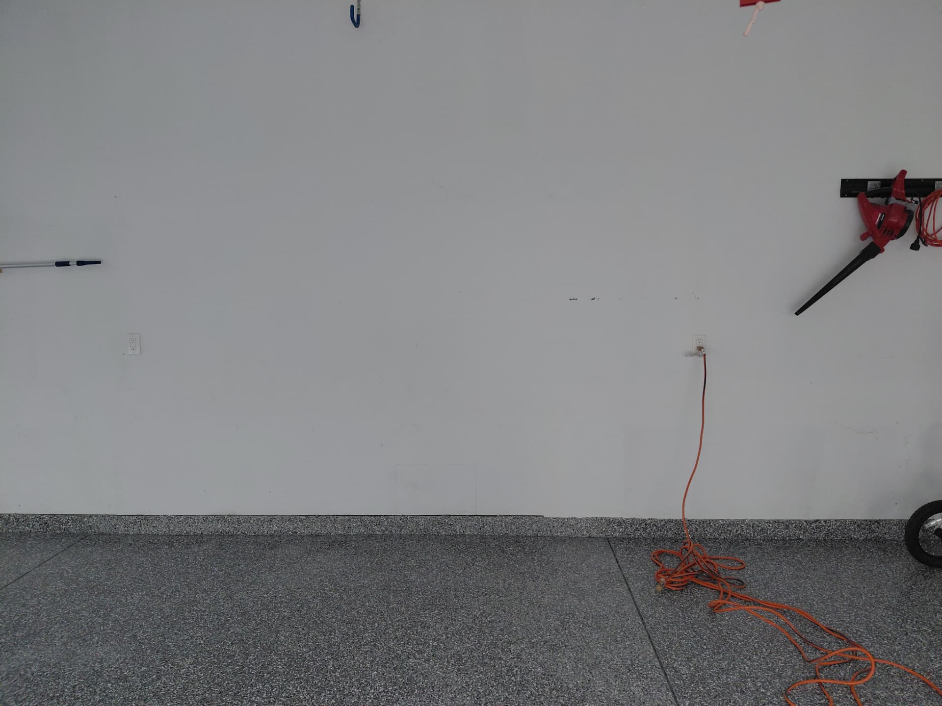Garage wall receptacles with an extension cord in use before a dedicated circuit was added