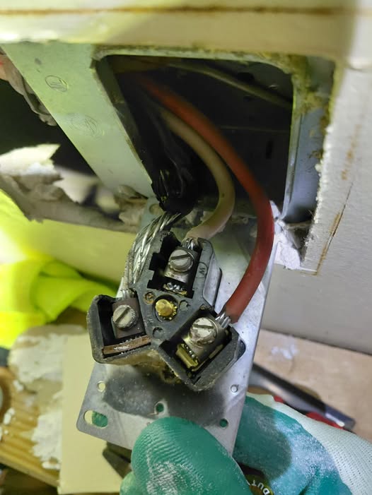 Heat-damaged dryer receptacle requiring electrical repair