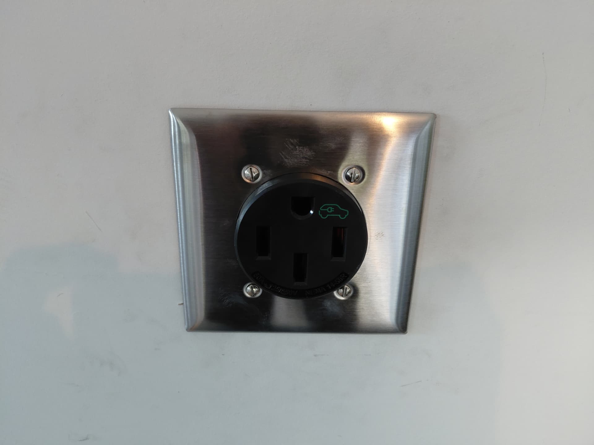NEMA 14-50 EV charging receptacle installed by ALM Electric on a garage wall